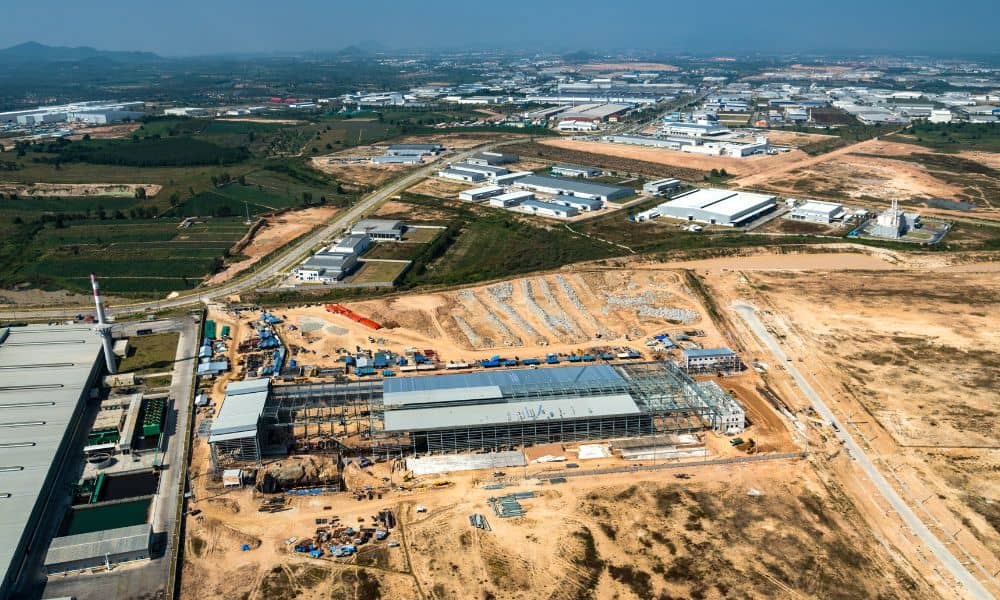 Aerial view of large-scale land development and surrounding terrain during an environmental impact assessment for responsible project planning
