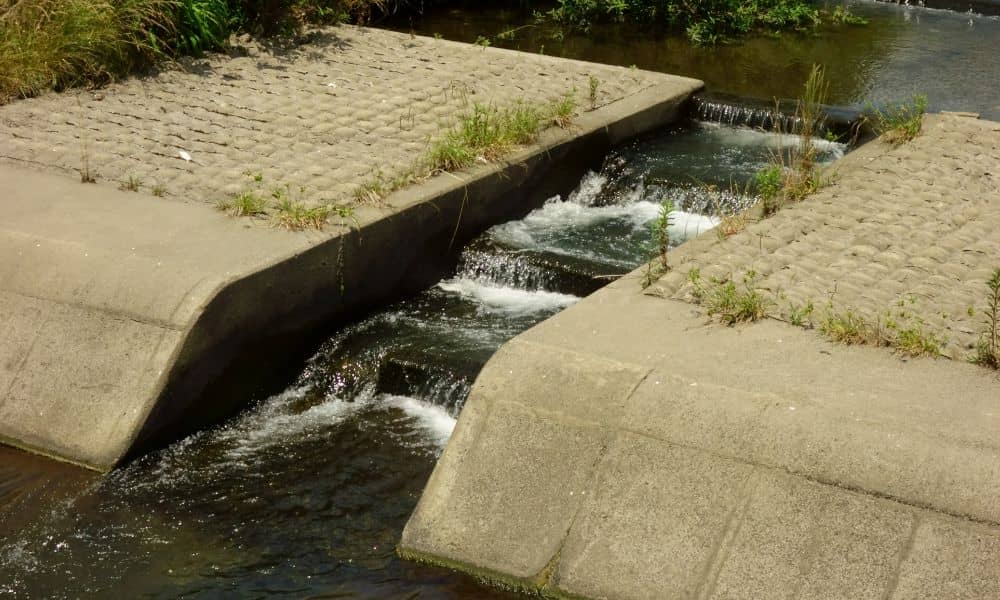 Concrete drop structure in a drainage channel controlling water flow and preventing erosion