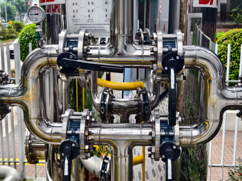 Industrial pipe system with valves and fittings used to illustrate head loss caused by friction, turbulence, and flow resistance