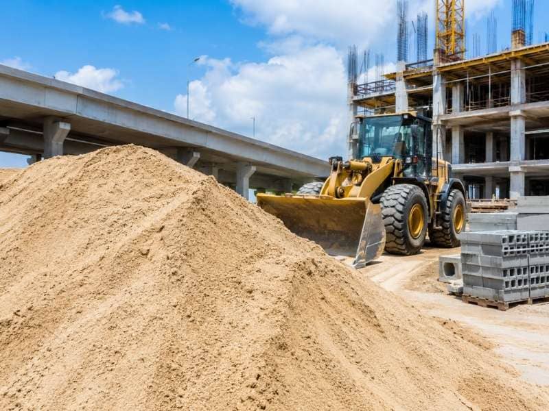 Sand used as a construction material, showing fine mineral particles commonly used in concrete, mortar, road construction, and infrastructure projects.